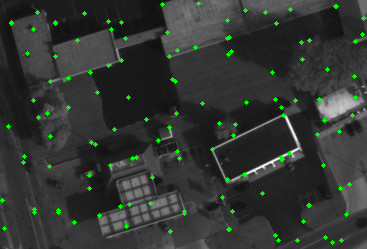 Aerial image with a sparse set of green dots indicating pixels used in the optimization.